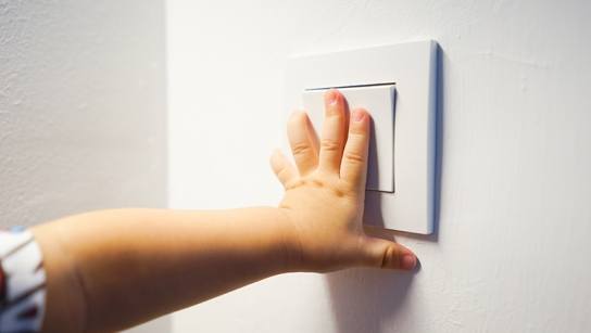 Hand switching on a light switch
